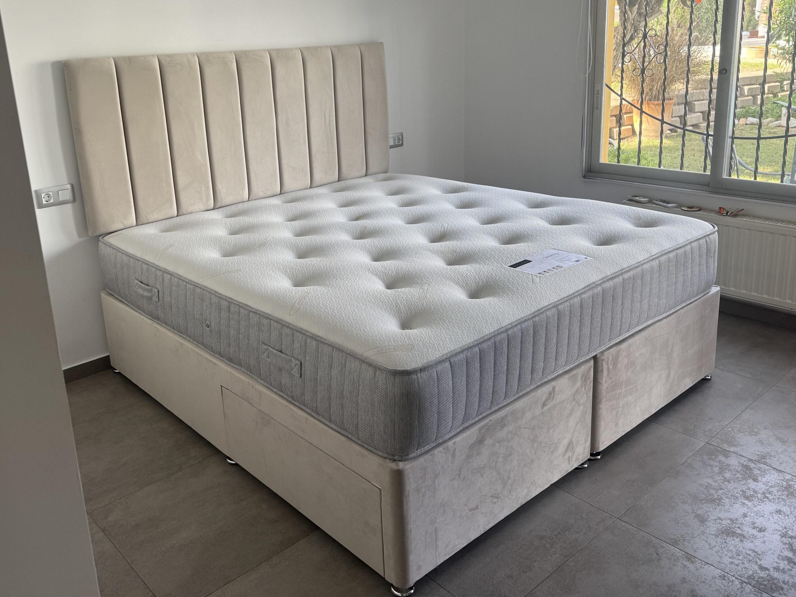 Tall plush cream headboard and divan in a customer’s home