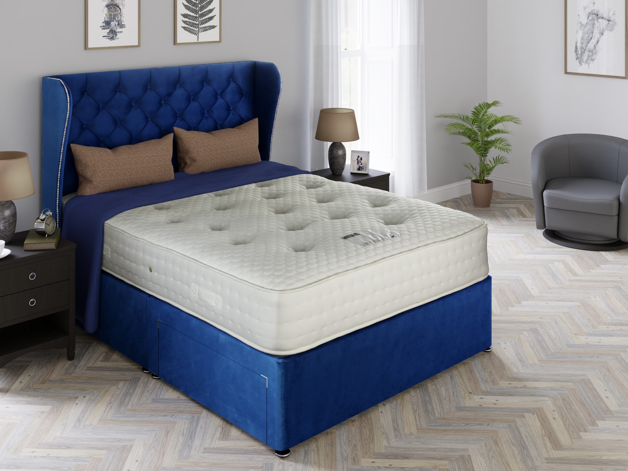 Grandeur mattress on a blue velvet divan with a buttoned winged headboard